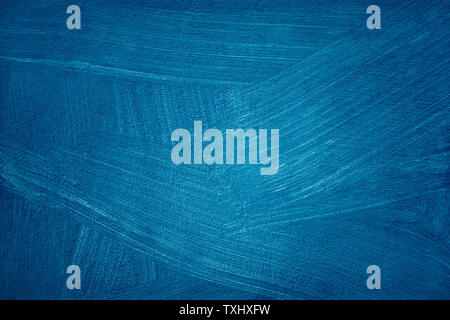A blue colored old wall plaster texture with visible brush traces. Stock Photo