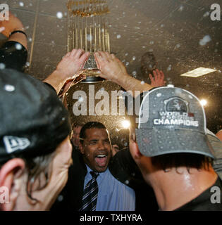 Chicago White Sox manager Ozzie Guillen hoists the World Series trophy  after beating the Houston Astros 1-0 in game 4 of the World Series, October  26, 2005 in Houston, TX. The White