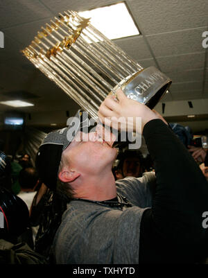 Chicago White Sox manager Ozzie Guillen hoists the World Series trophy  after beating the Houston Astros 1-0 in game 4 of the World Series, October  26, 2005 in Houston, TX. The White