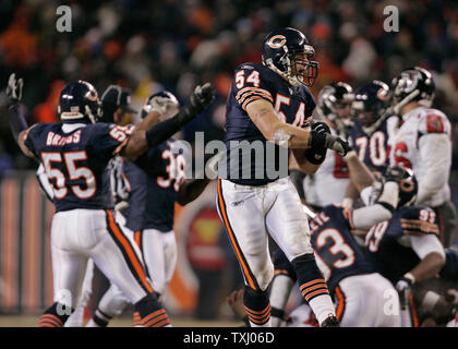 Chicago Bears' Brian Urlacher (54) holds up the NFC Championship Trophy  after the Bears beat the New Orleans Saints 39-14 in the NFC Championship  game at Soldier Field in Chicago on January