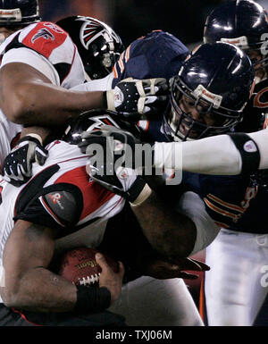 Atlanta Falcons running back T. J. Duckett (45) pushes past the Tampa Bay  Buccaneers defense including linebacker Shelton Quarles (53) for the first  of two first half touchdowns at the Georgia Dome