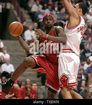 Cleveland Cavaliers' LeBron James, left, passes the ball around Chicago Bulls' Tyson Chandler during the first quarter on December 22, 2005 in Chicago. (UPI Photo/Brian Kersey) Stock Photo