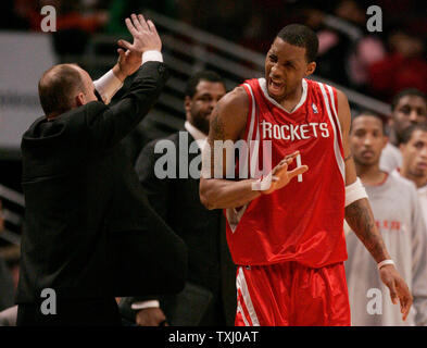 Houston Rockets ' Tracy McGrady reacts in front of a huge jersey