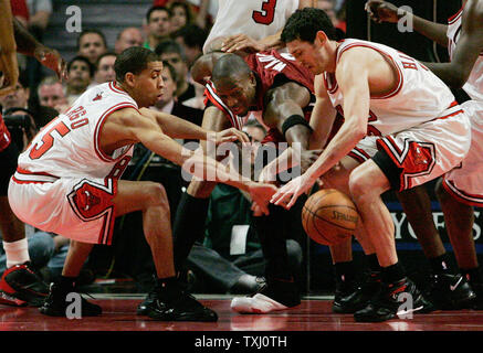 Chicago Bulls' Kirk Hinrich, right, and Jannero Pargo, left, steal the ball from Miami Heat's Dwyane Wade during the second quarter of game 6 of the first round of the NBA playoffs, on May 4, 2006, in Chicago. (UPI Photo/Brian Kersey) Stock Photo
