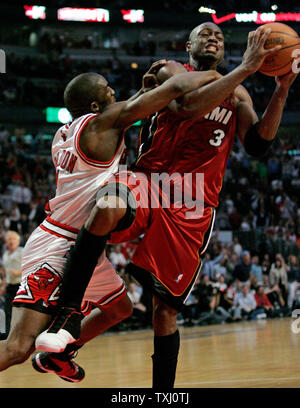 Chicago Bulls' Ben Gordon, left, fouls Miami Heat's Dwyane Wade as he goes up for a shot during the third quarter of game 6 of the first round of the NBA playoffs, in Chicago on May 4, 2006, in Chicago. The Heat won the game 113-96 beating the Bulls four games to two in a best of seven series. (UPI Photo/Brian Kersey) Stock Photo