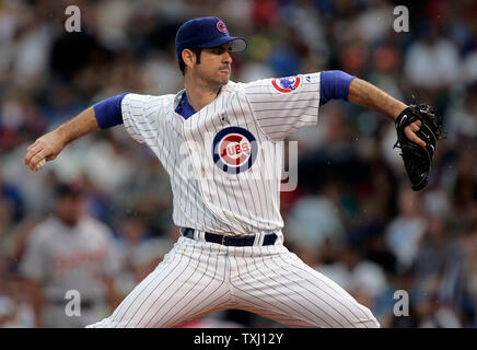 Chicago Cubs pitcher Mark Prior grimaces as he sits on the infield after  being hit on his pitching arm by a line drive off the bat of Colorado  Rockies outfielder Brad Hawpe