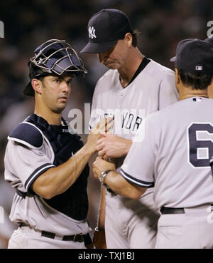 New York Yankees Randy Johnson and Jorge Posada talk on the mound after a 3  run homer by Tampa Bay Devil Rays Damon Hollins in the third inning at  Yankees Stadium in