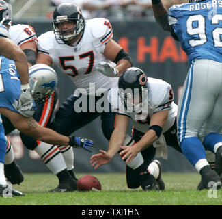 Chicago Bears quarterback Rex Grossman (R) recovers his own fumble as center Olin Kreutz (57) looks to block against the Detroit Lions, during the first quarter at Soldier Field in Chicago on September 17, 2006. The Bears won 34-7. (UPI Photo/Brian Kersey) Stock Photo