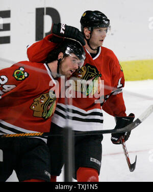 Chicago Blackhawks center Michael Holmqvist, right, of Sweeden, gives right wing Martin Havlat, of the Czech Republic, a hug after Havlat's empty-net goal against the Nashville Predators during the third period in Chicago, on October 12, 2006. The Blackhawks won 3-1. (UPI Photo/Brian Kersey) Stock Photo