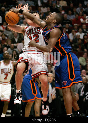 New York Knicks guard Steve Francis, right, fouls Chicago Bulls guard Kirk Hinrich (12) as he goes up for a shot during the fourth quarter in Chicago on November 28, 2006. The Bulls won 102-85. (UPI Photo/Brian Kersey) Stock Photo