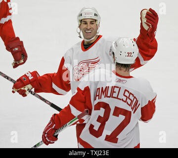 Detroit Red Wings' Chris Chelios, left, and Mikael Samuelsson (37), of Sweden, celebrate Samuelsson's goal during the third period against the Chicago Blackhawks in Chicago on December 14, 2006. The Red Wings won 3-2. (UPI Photo/Brian Kersey) Stock Photo