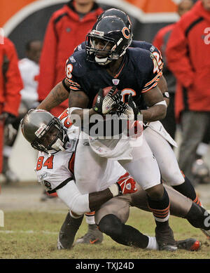 Tampa Bay Buccaneers' wide receiver Joey Galloway (84) is tackled by Atlanta  Falcons' linebacker Keith Brooking (56) during the Bucs 27-0 win in a game  up against the Falcons at Raymond James