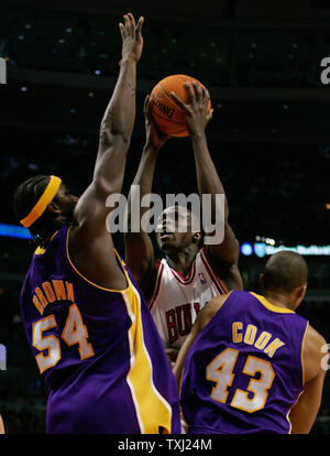 Chicago Bulls' Luol Deng, center, goes up for a shot as Los Angeles Lakers' Kwame Brown (54) and Brian Cook (43) defend during the second quarter in Chicago on December 19, 2006. The Bulls won 94-89. (UPI Photo/Brian Kersey) Stock Photo