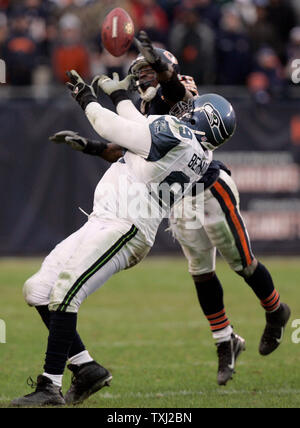 Chicago running Thomas Jones gets wrapped up by two Dallas defenders during  the Cowboys-Bears Thanksgiving Day game in Irving, TX on Nov. 25, 2004. The  Cowboys defeated the Bears 21-7. (UPI Photo/Ian