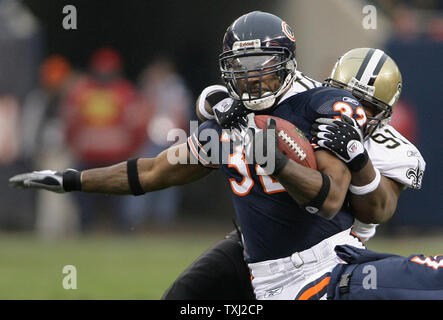 Chicago Bears running back Cedric Benson (32) is brought down by New Orleans Saints defensive end Will Smith (91) after a 5-yard run in the first quarter of the NFC Championship game at Soldier Field in Chicago on January 21, 2007. (UPI Photo/Joseph Oliver) Stock Photo