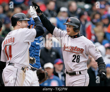 Houston Astros Morgan Ensberg (14) greets Adam Everett (28) at the plate after Everett hit a two-run homer scoring Ensberg during the eighth inning against the Chicago Cubs at Wrigley Field in Chicago on April 9, 2007. The Astros won 5-3. (UPI Photo/Brian Kersey) Stock Photo