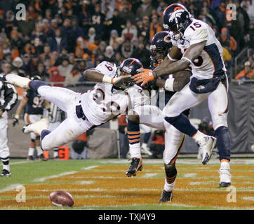 Chicago Bears cornerback Charles Tillman (C) breaks up a pass intended for Denver Broncos receiver Brandon Marshall (15) as tight end Daniel Graham (89) also tries to make a play during the second quarter at Soldier Field in Chicago on November 25, 2007. (UPI Photo/Brian Kersey) Stock Photo