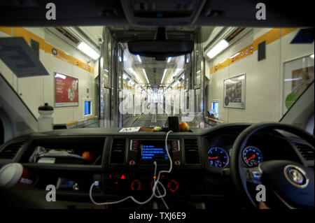 A van drives through a shuttle wagon, Eurotunnel Le Shuttle, Folkestone to Calais, Great Britain. Stock Photo