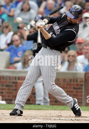 Colorado Rockies first baseman Todd Helton hugs Jarvis Torrealba,10, son of  catcher Yorvit during batting practice at the World Series game three at  Coors Field in Denver on October 27, 2007. (UPI