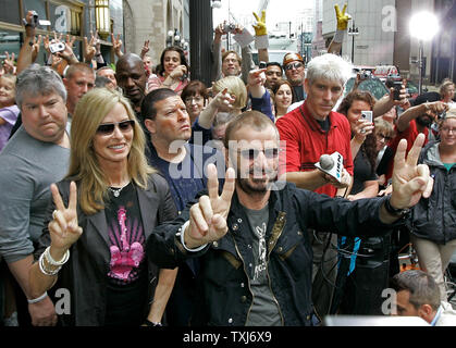 Former Beatle Ringo Starr (R) and his wife Barbara Bach greet fans with the peace sign in celebration of his 68th birthday in Chicago on July 7, 2008. Starr asked his fans around the world to show the peace sign at noon local time in honor of his birthday. (UPI Photo/Brian Kersey) Stock Photo