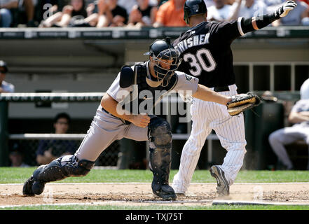 Chicago White Sox's Nick Swisher (30) scores from second base past the tag of Seattle Mariners catcher Jeff Clement after Juan Uribe hit a single during the third inning on August 20, 2008 in Chicago. (UPI Photo/Brian Kersey) Stock Photo