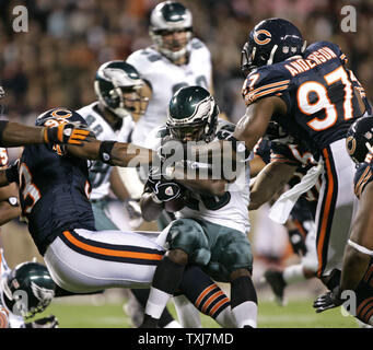 Seattle Seahawks corner back Marcus Trufant (23) reaches out for a low  tackle attempt of Philadelphia Eagles running back Correll Buckhalter (28)  during first quarter play at Philadelphia's Lincoln Field December 2