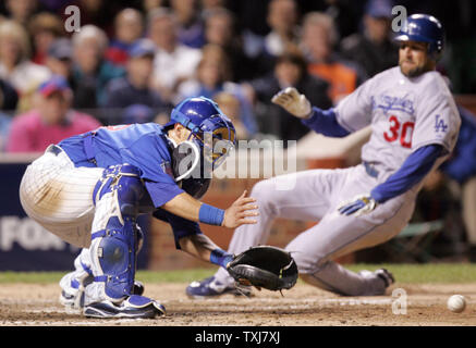 Los Angeles Dodgers base runner Casey Blake (30) slides into home before Chicago Cubs catcher Geovany Soto can make the tag during the eighth inning of game 2 in their National League Divisional Series at Wrigley Field in Chicago on October 2, 2008.(UPI Photo/Mark Cowan) Stock Photo