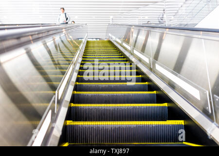 Narita, Japan train station elevator with salaryman people in bokeh background going up or down Stock Photo