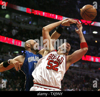 Orlando Magic center Marcin Gortat (L) fouls Chicago Bulls center Brad Miller (52) as they go up for a rebound during the fourth quarter at the United Center in Chicago on February 24, 2009. The Bulls won 120-102. (UPI Photo/Brian Kersey) Stock Photo