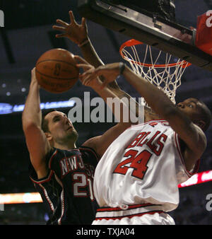 New Jersey Nets' Ryan Anderson puts up a shot as he gets by