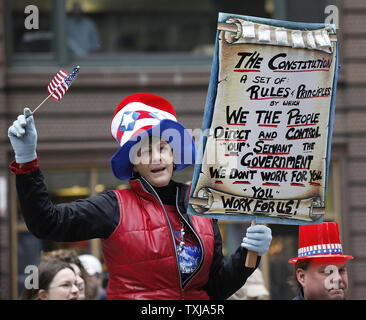 Marianne Ruiz of McHenry, Illinois holds up a sign at a 'tea party' anti-tax protest in Federal Plaza on April 15, 2009 in Chicago. Thousands attended the Chicago rally and hundreds of other protests were organized in cities across the country on national tax day to express concern over excess government spending. (UPI Photo/Brian Kersey) Stock Photo