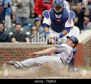 New York Mets first baseman Daniel Murphy (28) is tagged out by Chicago Cubs catcher Geovany Soto (18) at home plate in the eighth inning at Wrigley Field in Chicago on August 28, 2009. UPI /Mark Cowan Stock Photo