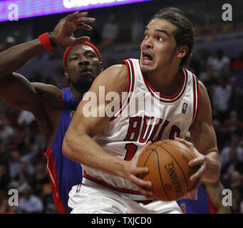 Chicago Bulls center Joakim Noah (R) drives to the hoop as Detroit Pistons center Ben Wallace defends during the fourth quarter at the United Center in Chicago on December 2, 2009. The Bulls won 92-85.     UPI/Brian Kersey Stock Photo