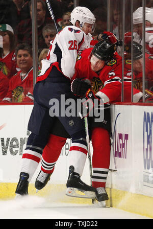 Washington Capitals defenseman Shaone Morrisonn (L) checks Chicago Blackhawks defenseman Brent Sopel into the boards during the first period at the United Center in Chicago on March 14, 2010.     UPI/Brian Kersey Stock Photo