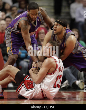 Phoenix Suns center Channing Frye (L), forward Jared Dudley (R) and Chicago Bulls center Joakim Noah go for a loose ball during the second quarter at the United Center in Chicago on March 30, 2010.     UPI/Brian Kersey Stock Photo