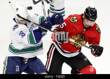 Vancouver Canucks right wing Pavol Demitra (L) and Chicago Blackhawks defenseman Brent Sopel go for the puck during the first period of game 2 of the NHL Western Conference semifinals at the United Center in Chicago on May 3, 2010.     UPI/Brian Kersey Stock Photo