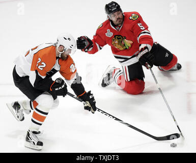 Philadelphia Flyers left wing Ville Leino (22) tries to bring the puck up the ice past Chicago Blackhawks defenseman Brent Sopel (5) during the third period of game 2 of the 2010 Stanley Cup Final at the United Center in Chicago, May 31, 2010. The Blackhawks defeated the Flyers 2-1 to take a 2-0 lead in the best of seven series. (UPI Photo/Mark Cowan) Stock Photo