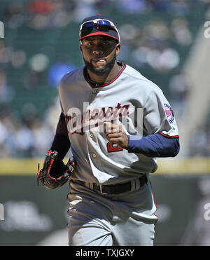 Minnesota Twins third baseman Nick Punto #8 slides into third base on a  single by Denard Span #2 in the 2nd inning of the Twins' baseball game  against the Chicago White Sox