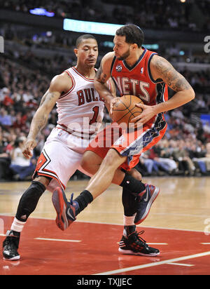 New Jersey Nets guard Deron Williams (R) drives to the basket as Chicago  Bulls guard Derrick Rose defends during the third quarter at the United  Center on January 23, 2012 in Chicago. The Bulls won 110-95. UPI/Brian  Kersey Stock Photo - Alamy