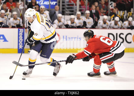 Chicago Blackhawks right wing Michael Frolik (R) tries to steal the puck from Nashville Predators right wing Alexander Radulov during the third period at the United Center on March, 25, 2012 in Chicago. The Predators won 6-1.     UPI/Brian Kersey Stock Photo