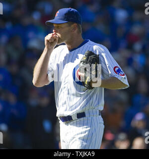 Chicago Cubs pitcher Kerry Wood plays with his son Justin, 2, in the  outfield after the Cubs beat the St. Louis Cardinals 5-4 to clinch the N.L.  Central Division at Wrigley Field