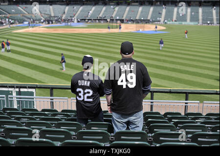 Chicago White Sox fans watch batting practice before a baseball game  against the New York Yankees, Thursday, Aug. 12, 2021 in Dyersville, Iowa.  The Yankees and White Sox are playing at a