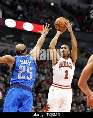 Chicago Bulls guard Derrick Rose (R) shoots as Dallas Mavericks guard Vince Carter defends during the second quarter at the United Center on April 21, 2012 in Chicago.     UPI/Brian Kersey Stock Photo