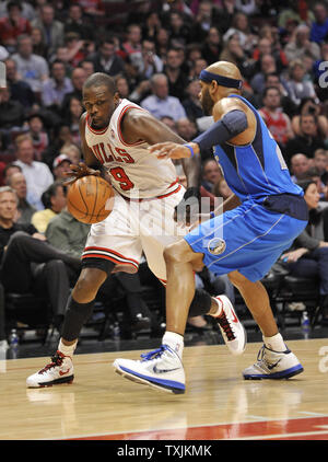 Chicago Bulls forward Luol Deng (L) drives on Dallas Mavericks guard Vince Carter during the second quarter at the United Center on April 21, 2012 in Chicago.     UPI/Brian Kersey Stock Photo