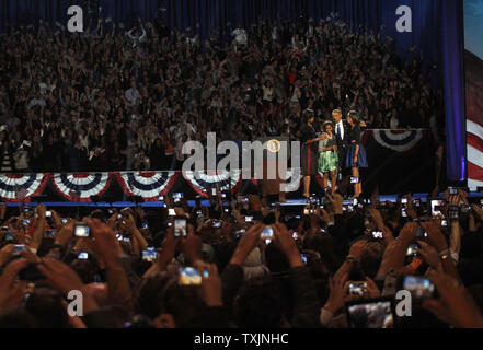 President Barack Obama stands on stage with his wife Michelle (L) and daughters Sasha and Malia before addressing supporters during his election night acceptance speech in Chicago on November 6, 2012. Obama defeated former Massachusetts Governor Mitt Romney to earn another four-year term as President. UPI/Frank Polich Stock Photo