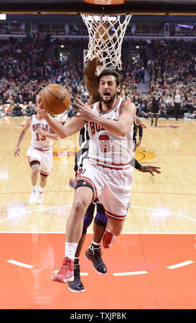 Brooklyn Nets forward Gerald Wallace (back) fouls Chicago Bulls guard Marco Belinelli of Italy during the first half at the United Center on December 15, 2012 in Chicago.     UPI/Brian Kersey Stock Photo