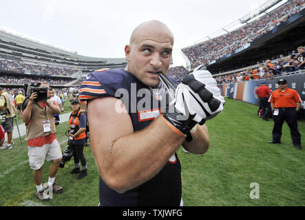 Chicago Bears offensive guard Kyle Long pulls off his gloves to give to  fans after the game against the Cincinnati Bengals at Soldier Field in  Chicago on September 8, 2013. The Bears