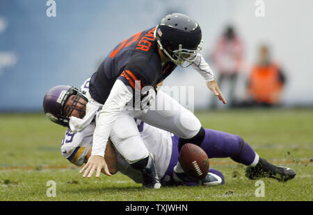 Chicago Bears' Jay Cutler fumbles the ball while being sacked by New ...