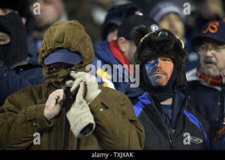 Fans stand bundled up against the cold weather at Soldier Field before an  NFL football game between the Chicago Bears and Green Bay Packers, Sunday,  Dec. 18, 2016, in Chicago. (AP Photo/Nam