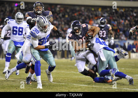 Chicago Bears tight end Dante Rosario (88) is tackled by Dallas Cowboys free safety Barry Church (42) after a 13-yard reception as Bears tackle Jermon Bushrod (L) blocks Cowboys strong safety Jeff Heath (38) during the second quarter at Soldier Field in Chicago on December 9, 2013.     UPI/Brian Kersey Stock Photo